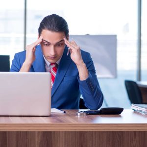 Young handsome businessman sitting in the office