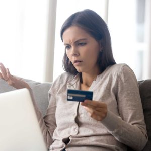Woman using online banking having problem with blocked credit card