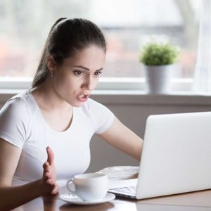 Indignant angry female has problems with laptop