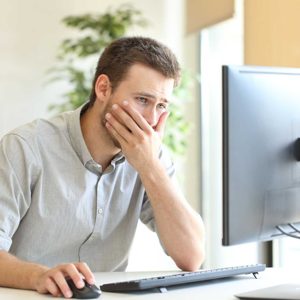 Worried businessman working online