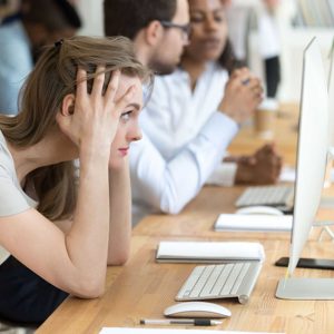 Stressed female employee having computer problem at work