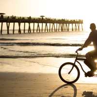 Bike riding in early morning on the beach.