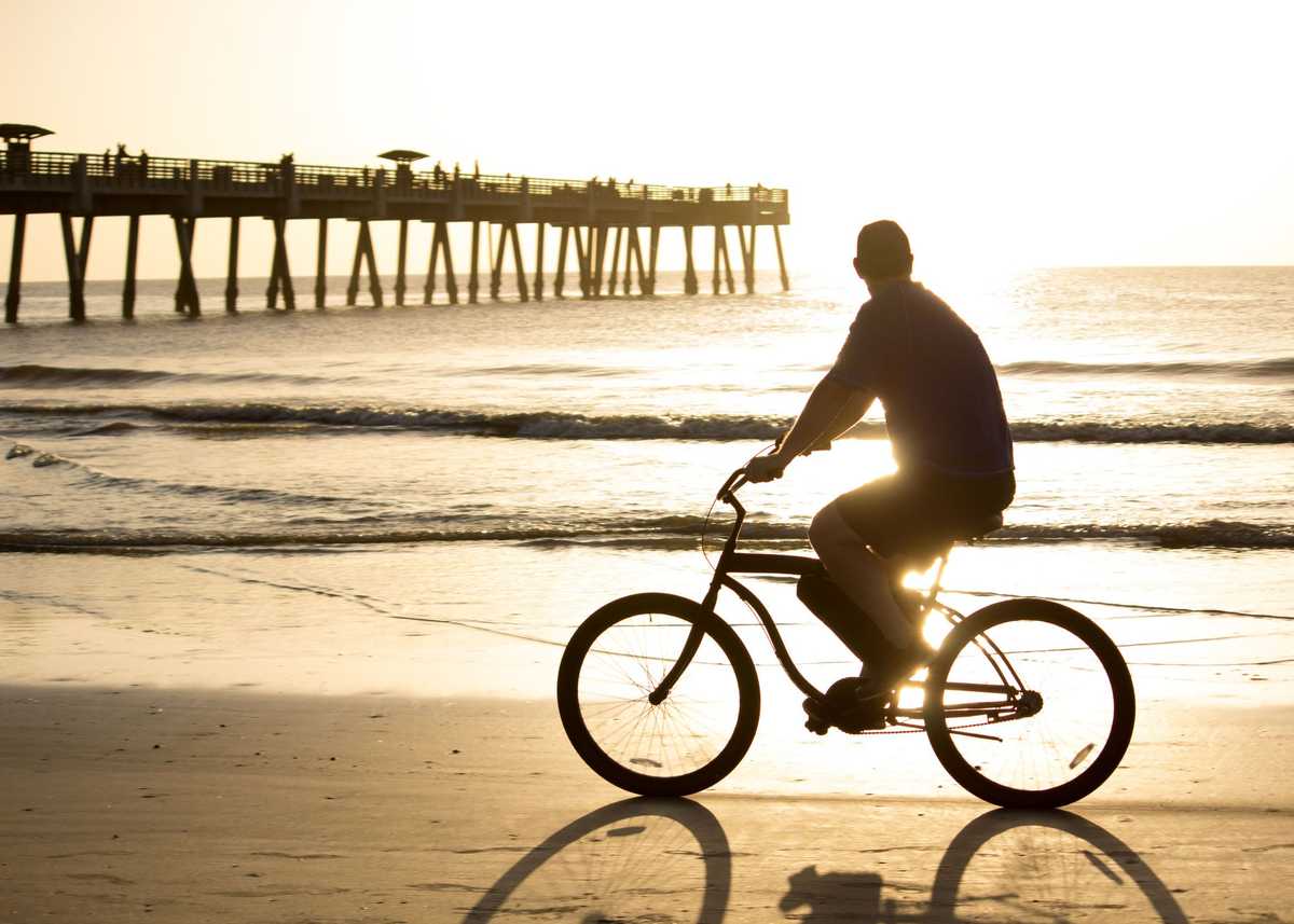 Bike riding in early morning on the beach.