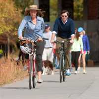 Atlanta, GA, USA - November 2, 2013:  A couple rides bikes as others exercise under a graffiti covered overpass that is part of the 22- mile Atlanta Beltline, an urban redevelopment project that will eventually connect 45 intown neighborhoods.