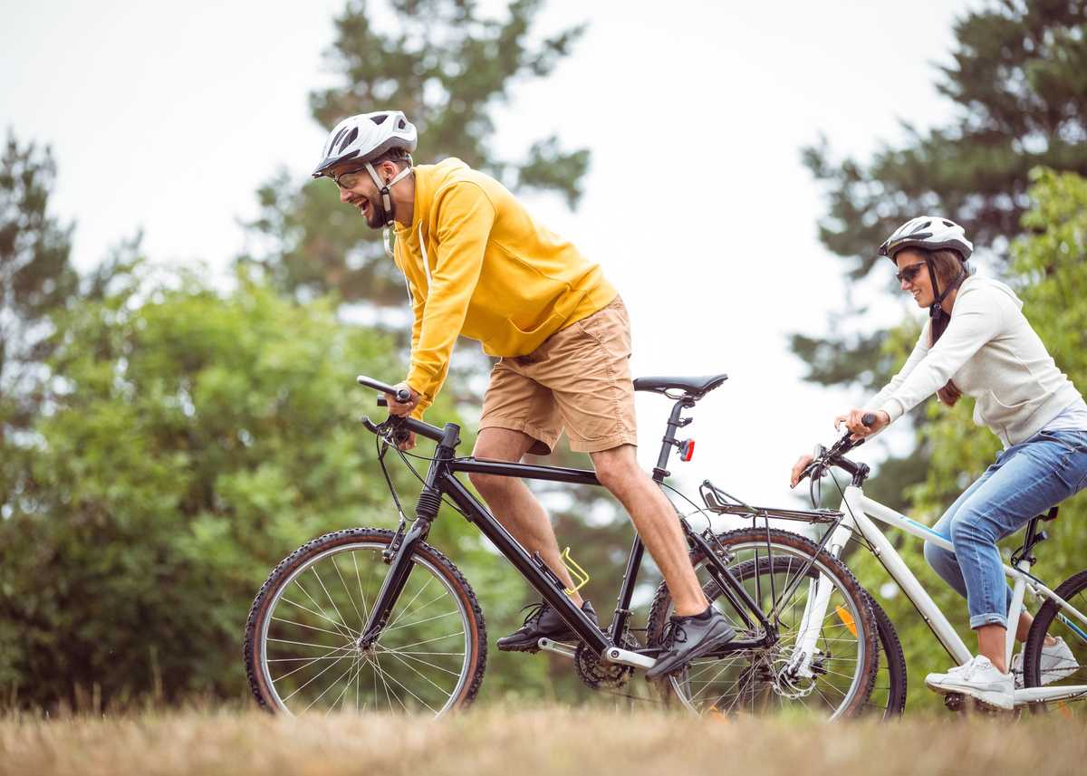 Happy couple on a bike ride in the countryside