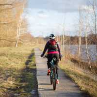 Photo of spring park and girl on bicycle