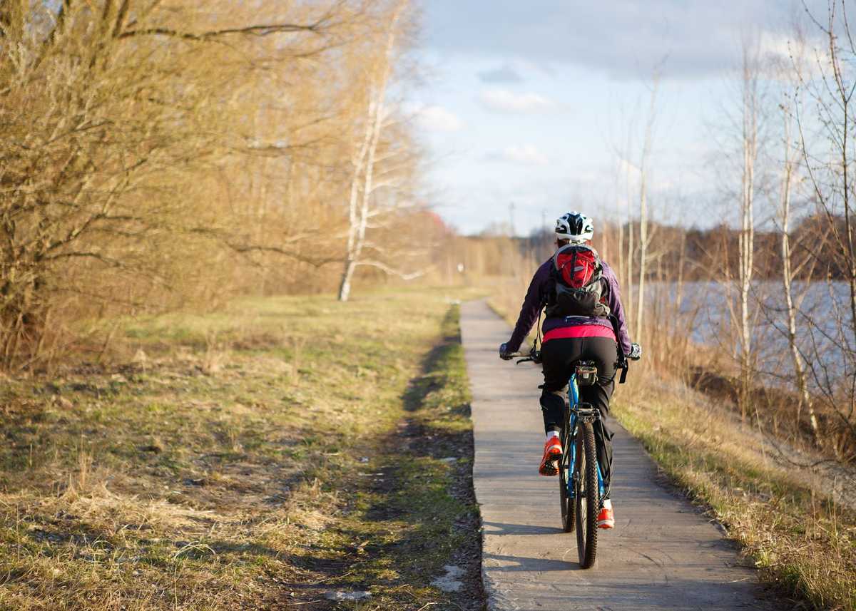 Photo of spring park and girl on bicycle