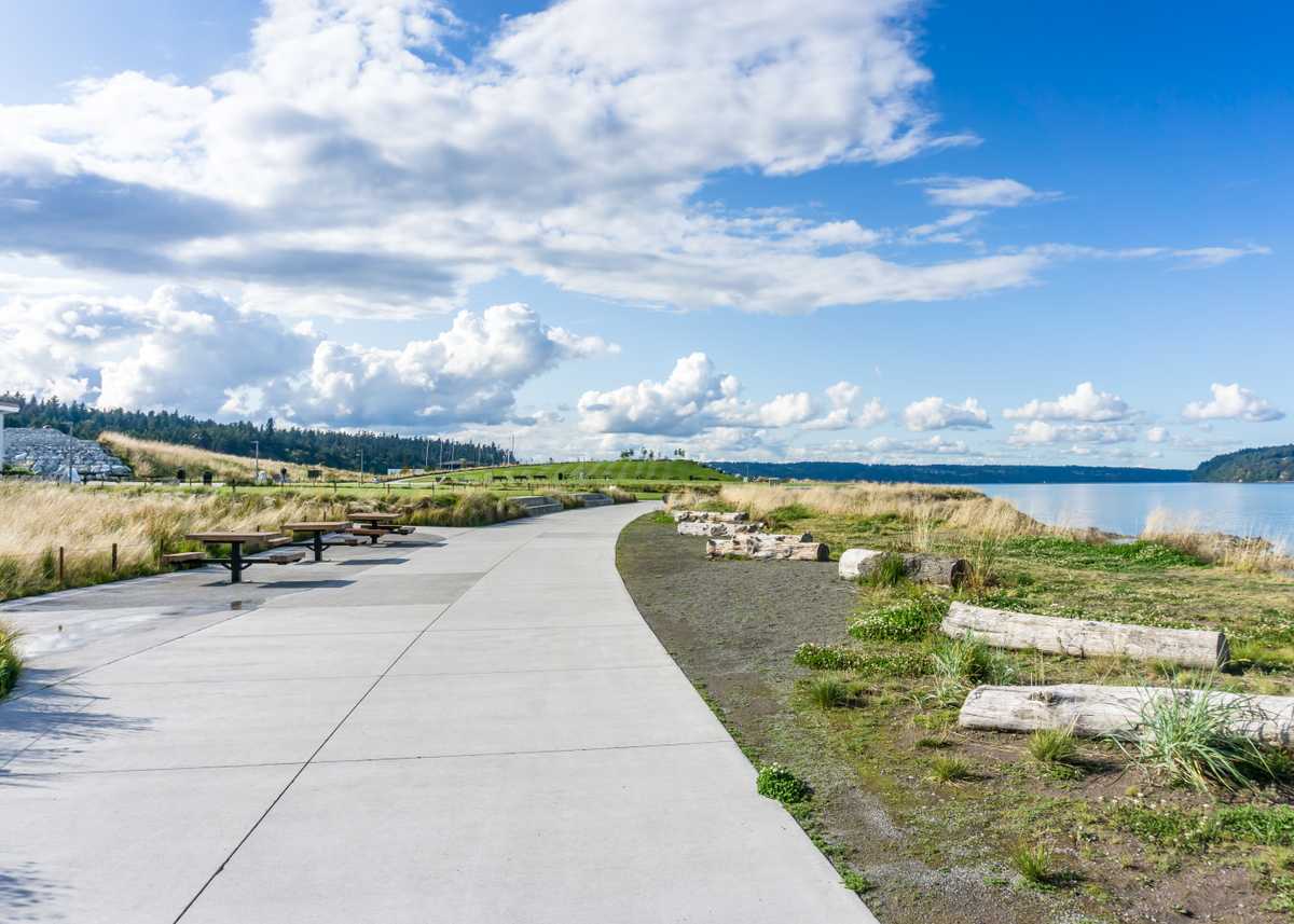 Billowing clouds hover over the Puget Sound and Dune Peninsula Park in Tacoma, Washington.