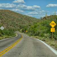 share the road with bicycles sign on empty road in arizona